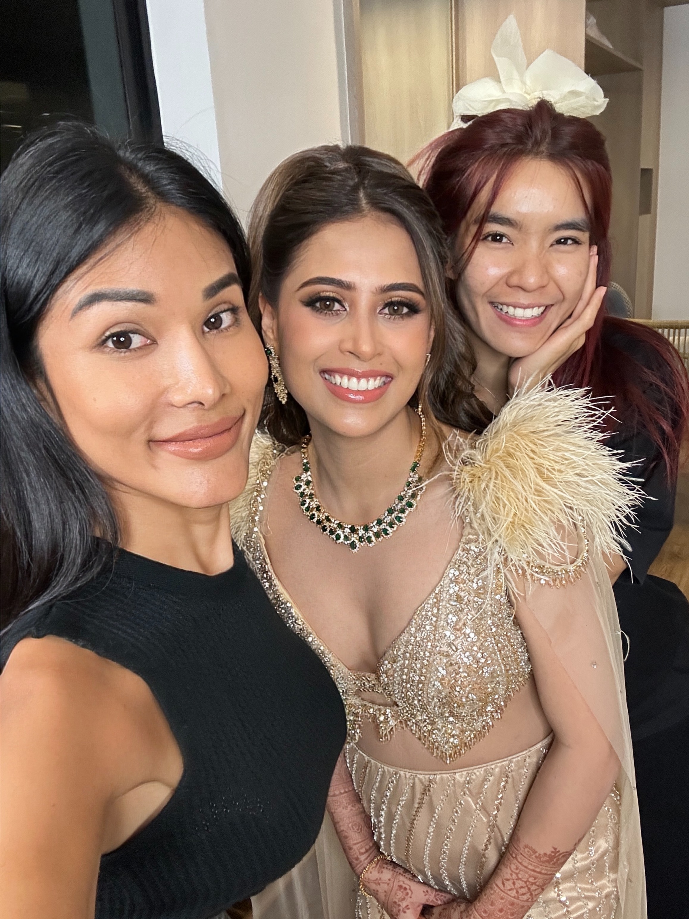 Kookkai applying Indian bridal makeup on a client